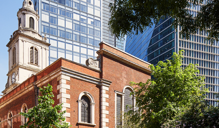 View of St Botolph-without-Bishopsgate Church surrounded by contemporary office buildings near MYO Liverpool Street.
