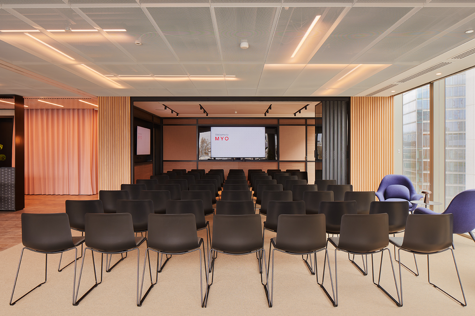 Event space at MYO Liverpool Street arranged in theatre style with presentation screens, flexible seating and contemporary interiors for corporate events and workshops.