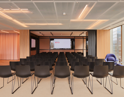 Event space at MYO Liverpool Street arranged in theatre style with presentation screens, flexible seating and contemporary interiors for corporate events and workshops.