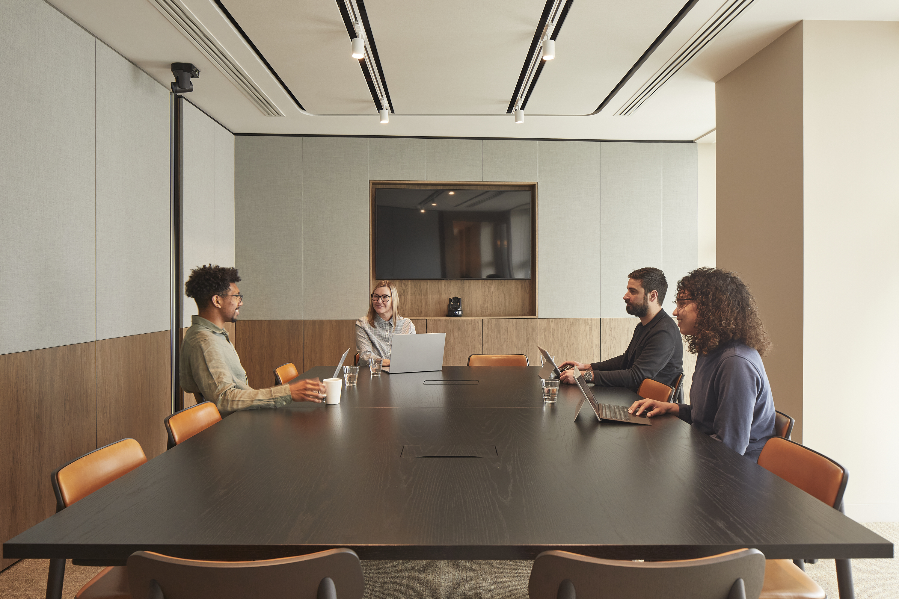Four professionals seated together in MYO Piccadilly Lucent Lounge