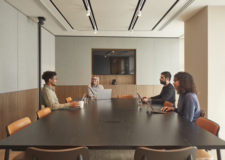 Four professionals seated together in MYO Piccadilly Lucent Lounge