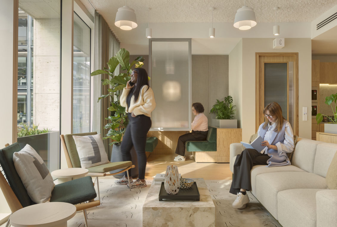 Three members using separate areas of MYO's modern workspace featuring comfortable seating and contemporary design.