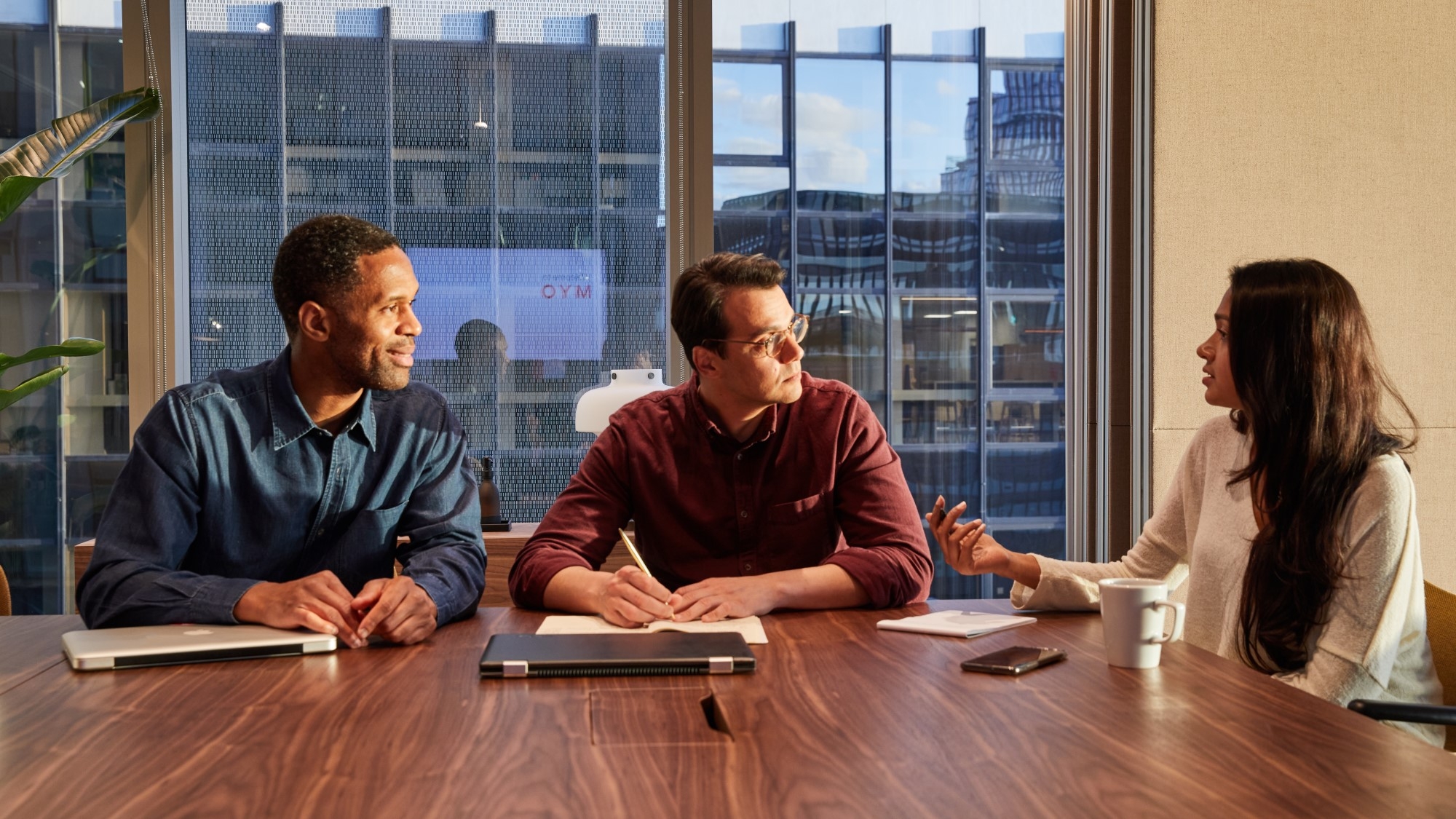 Three professionals meet in assembly meeting room 2