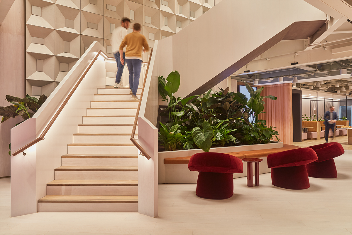 Members moving through MYO's contemporary workspace featuring statement staircases, lounge seating and integrated planting.