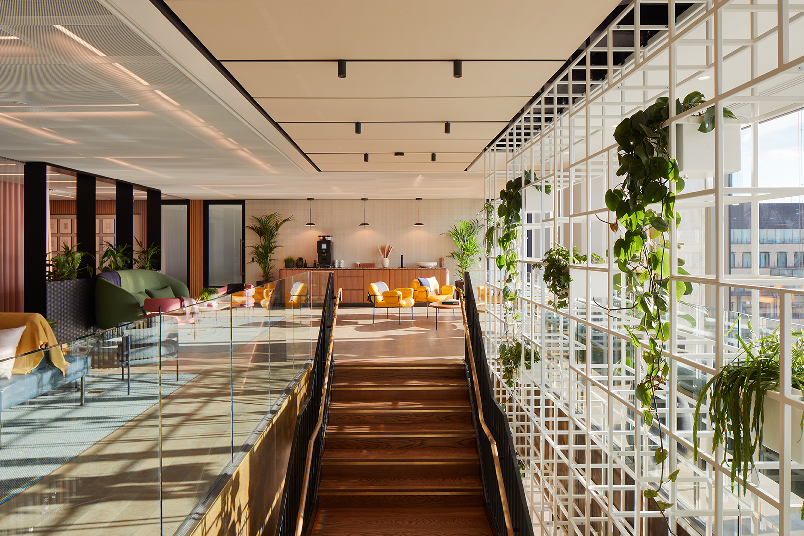 A stylish staircase leads to a bright, welcoming lounge space