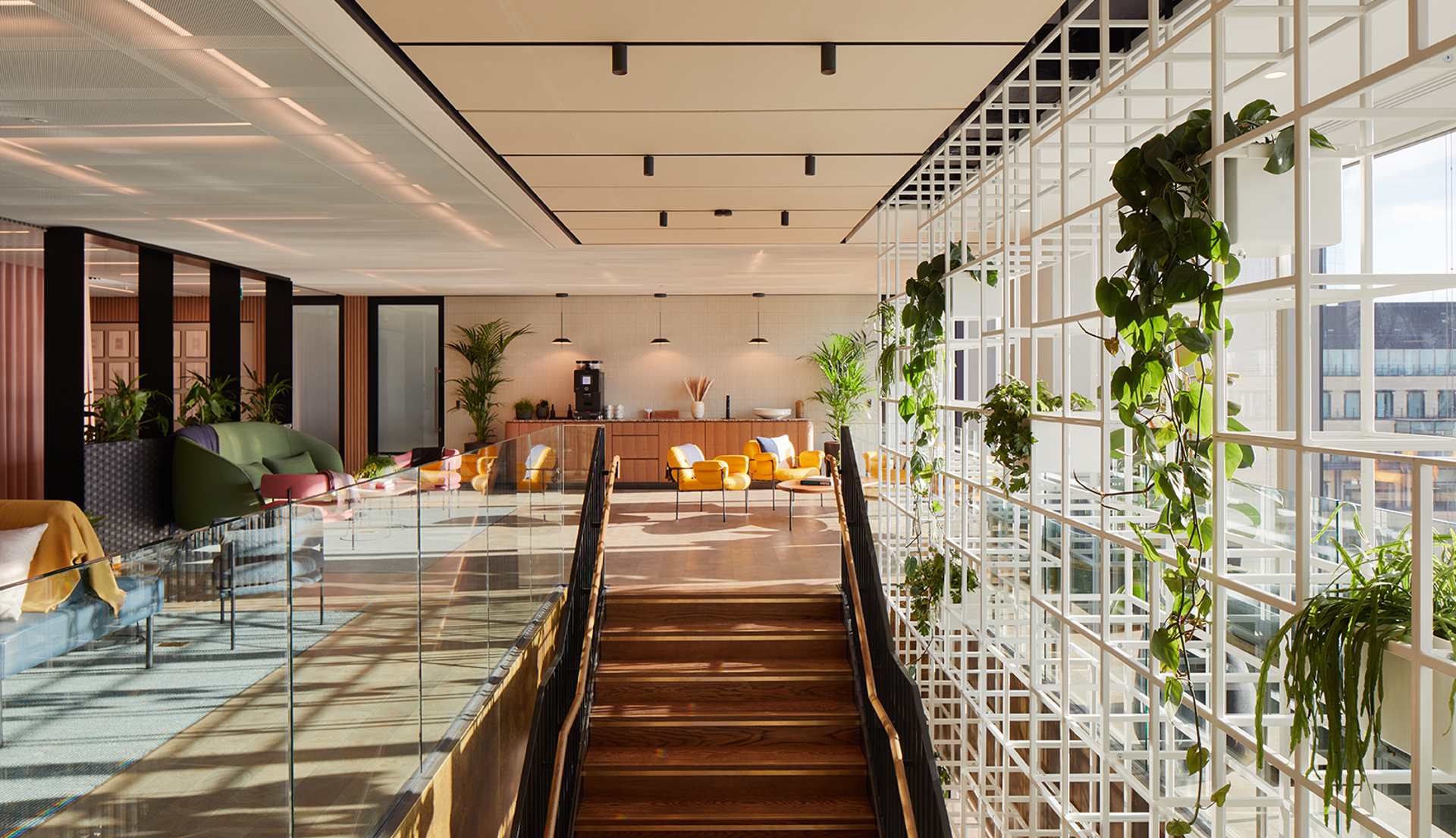 A stylish staircase leads to a bright, welcoming lounge space